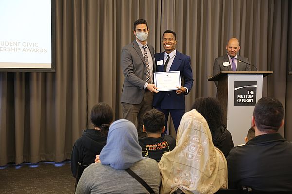 A photo of Darius receiving his Awards for his acts of civic service.