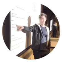 Mikhail explains code on the board