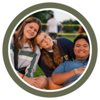 Photo of three students smiling for the camera