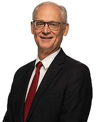 Brandon Beck, M.M., smiles for a portrait photo.