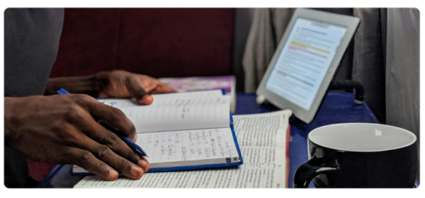student studies the Bible and makes notes