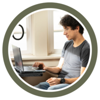 Photo of a student at The Atlas scrolling on his laptop