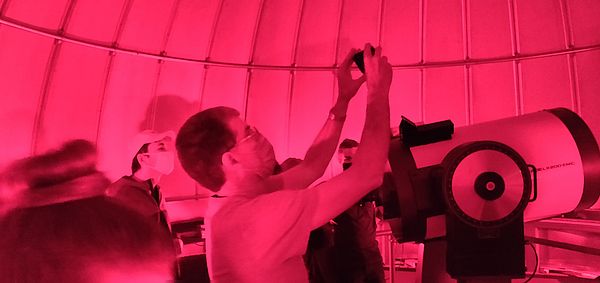 A group of people using the telescope.