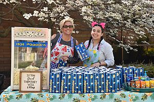 Deans giving out popcorn outside residence hall