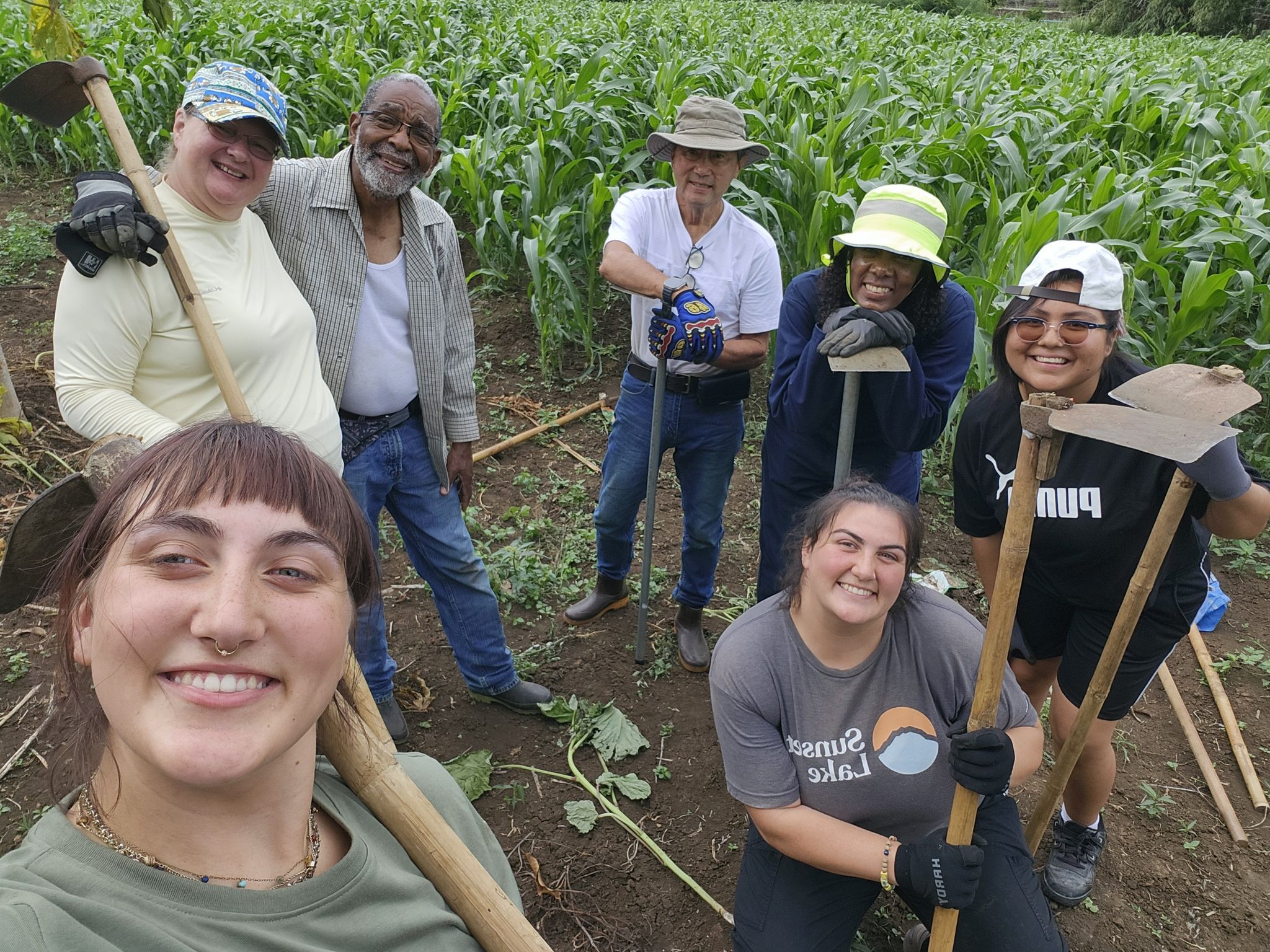 Group selfie of Maynard-Reid and the students helping farm