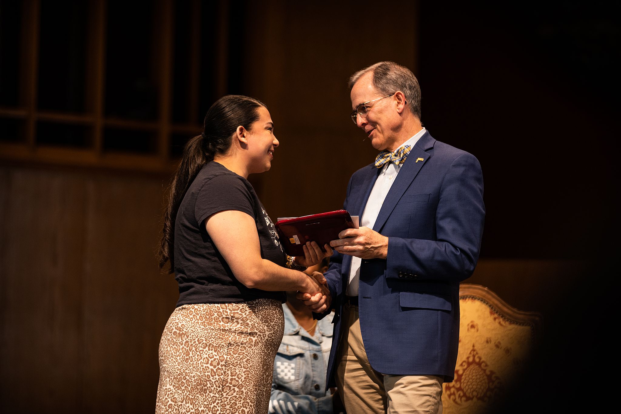 A staff member being presented an award by President McVay.