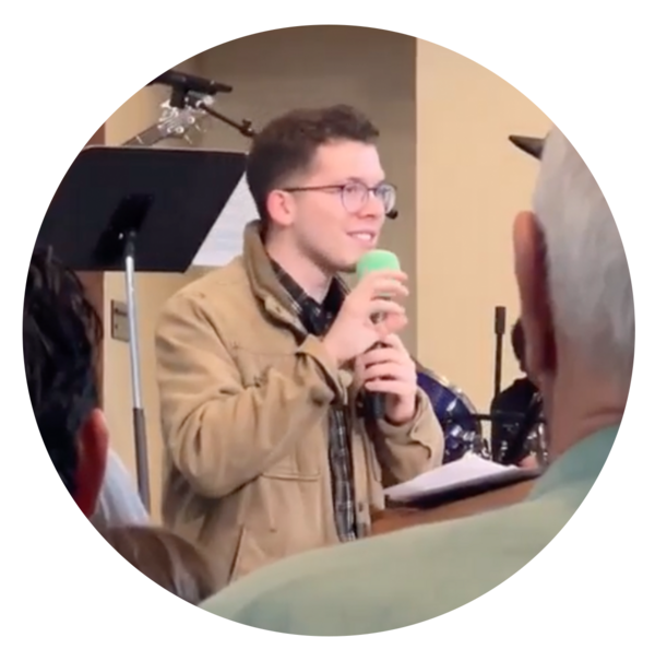 Isaac speaking with microphone