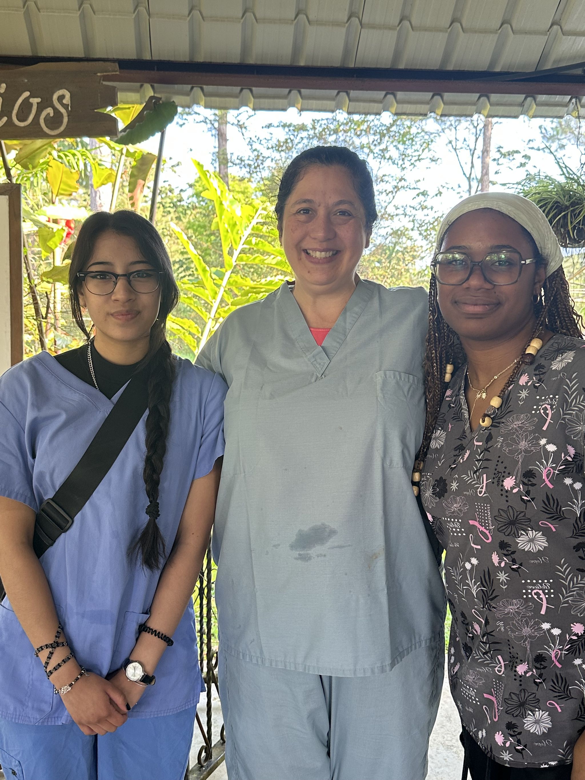 Group photo of Allison, Aven, and a volunteer doctor