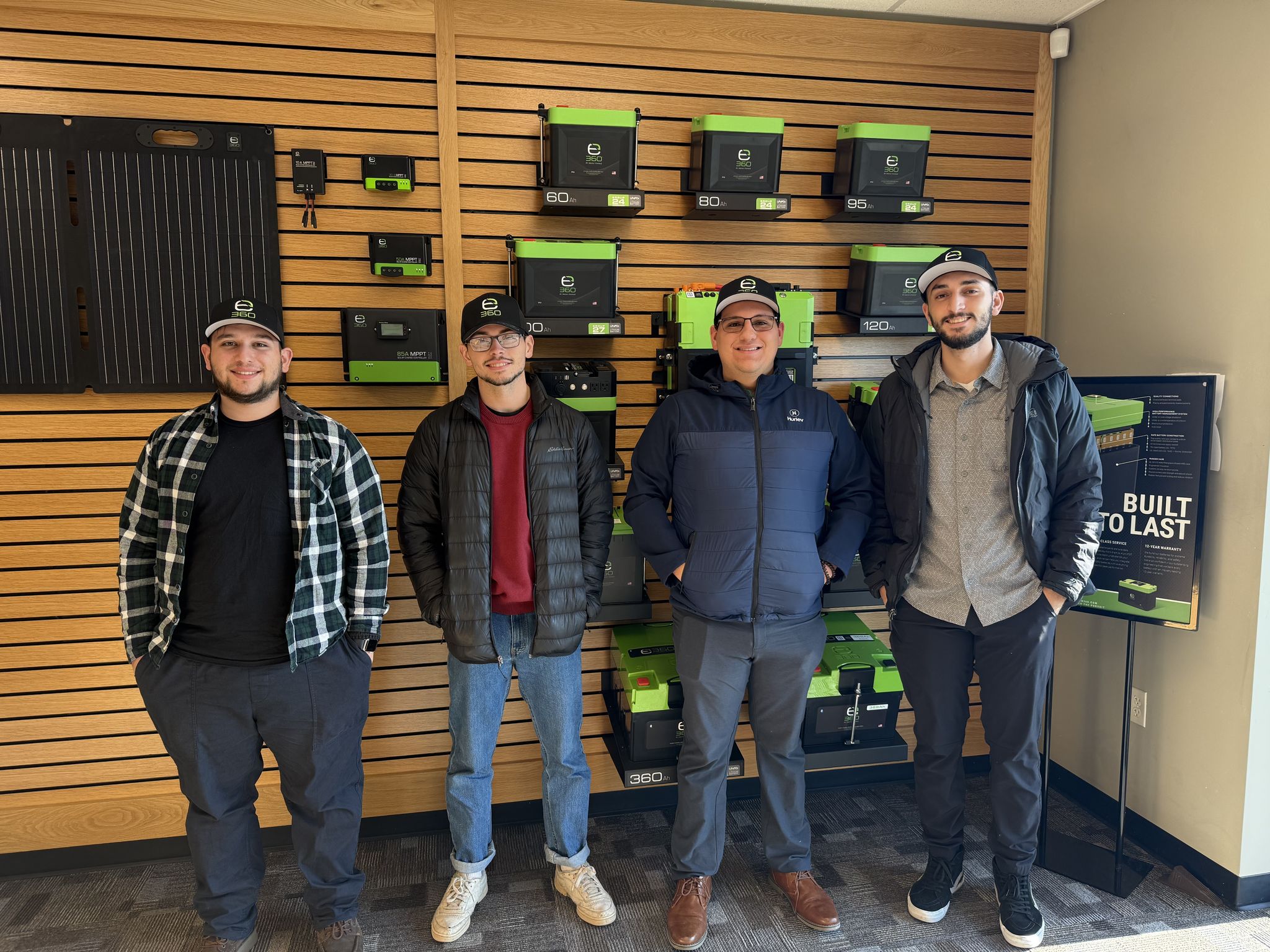 Four business students standing together and smiling while on field trip.
