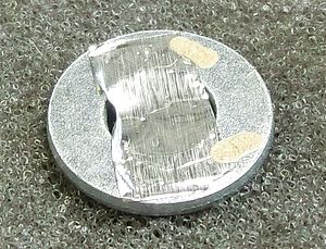 Aluminum foil attached to a washer.