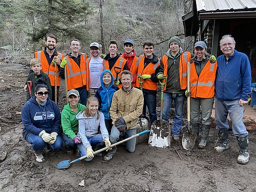 Students and Volunteers stand together in a group after a day of work.
