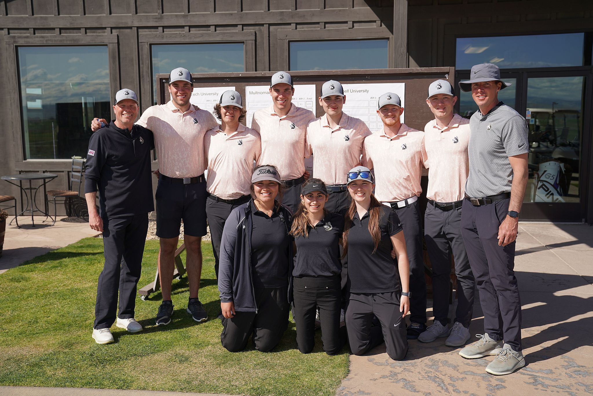 The golf team smiles together for a group photo. 