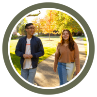 Photo of two students walking in front of Sittner Hall on a sunny day