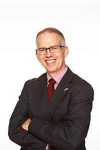 Carl Cosaert stands against a white background.