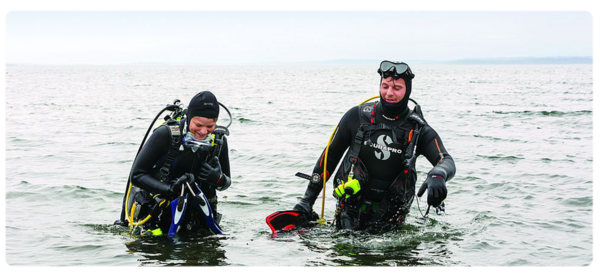 Marine biologists surface from a dive in the ocean