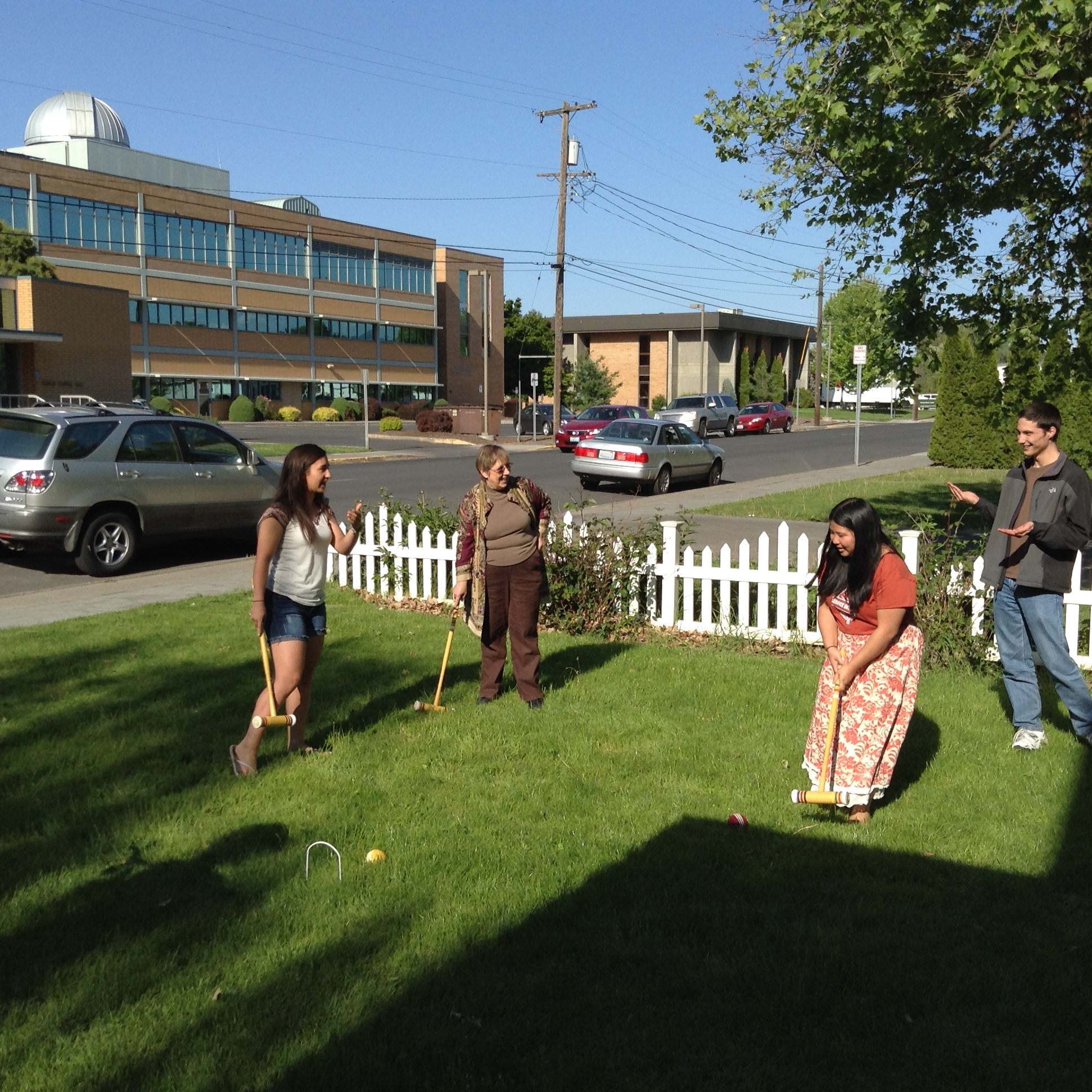 Students and WW professor emeritus of English Beverly Beem play Croquet in the Honors House front lawn.