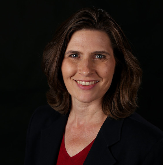 Portrait photo of Lynelle Ellis wearing a suit jacket and red shirt.