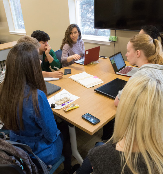 A group of students works together at a table.