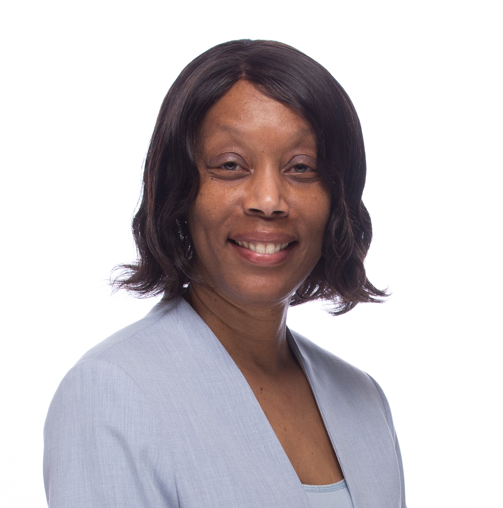 A smiling, African American woman in a pale purple sweater 