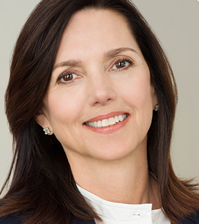 Portrait of Beth Comstock in white shirt and dark blazer