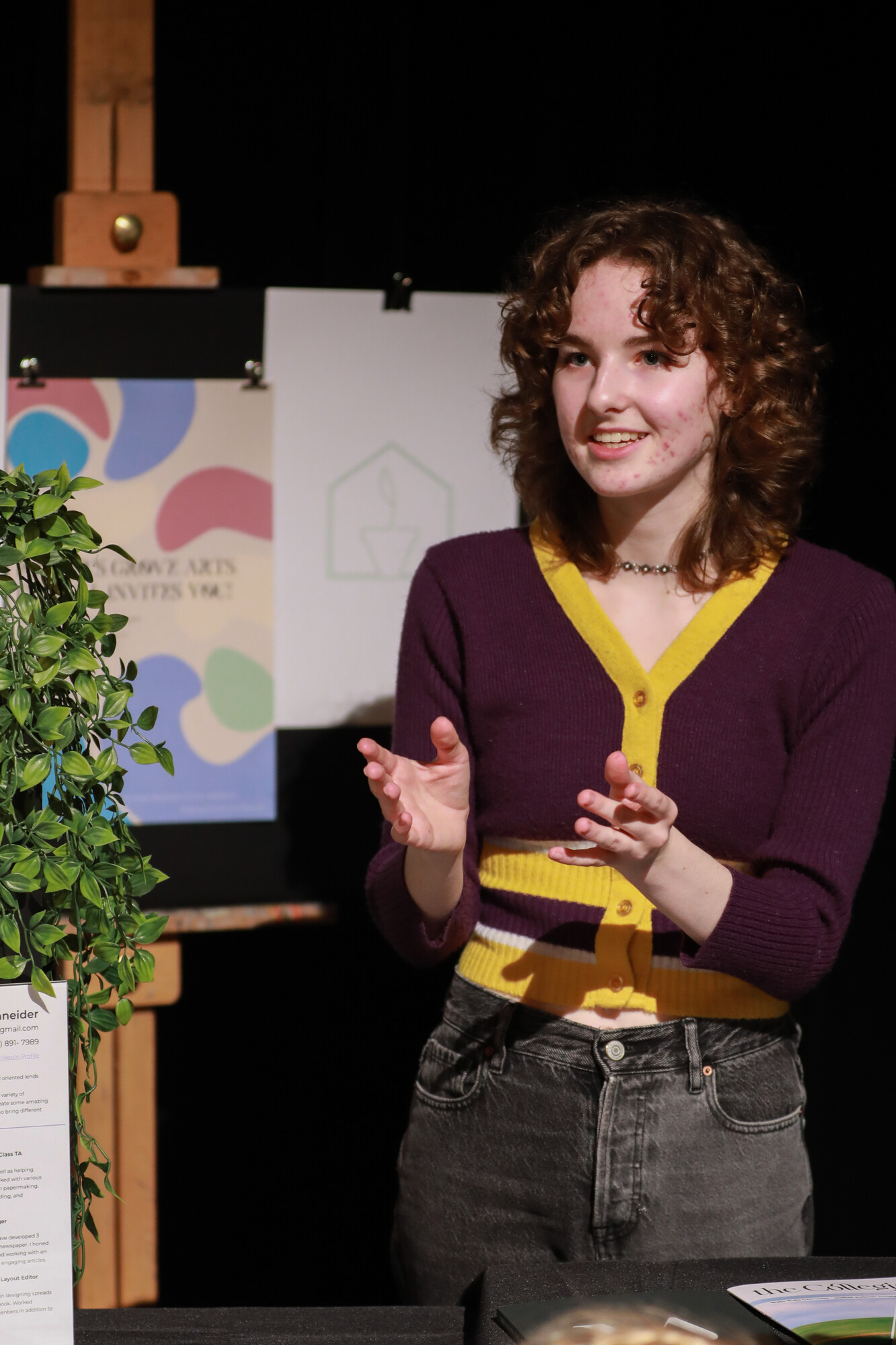 Student Cascadia Schneider explains one of her poster designs.