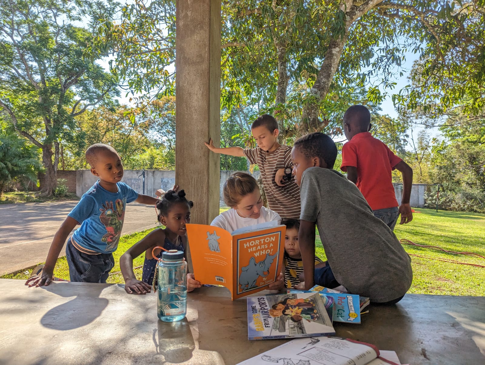 Madelyn reads to her students outside