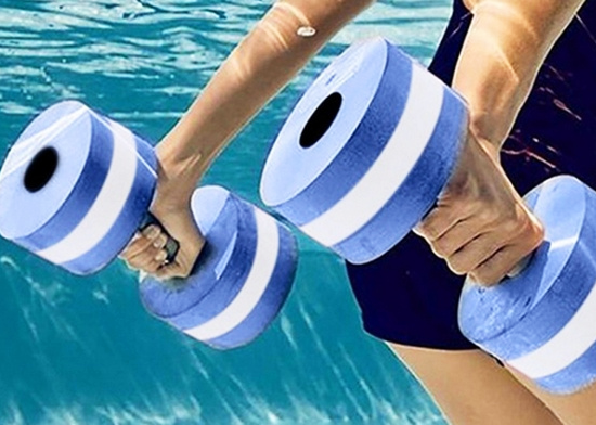 Water aerobics student uses water weights in the pool.