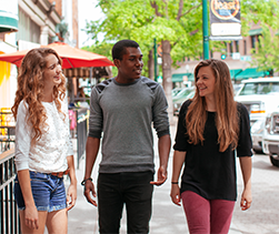 Three students walking downtown